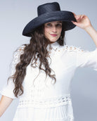 Model wearing Monica 5" & 7" Wide Brim Black Packable Straw Sun Hat handmade loomed raffia in a solid hue of black lightweight malleable flexible sun protection hat - Shebobo