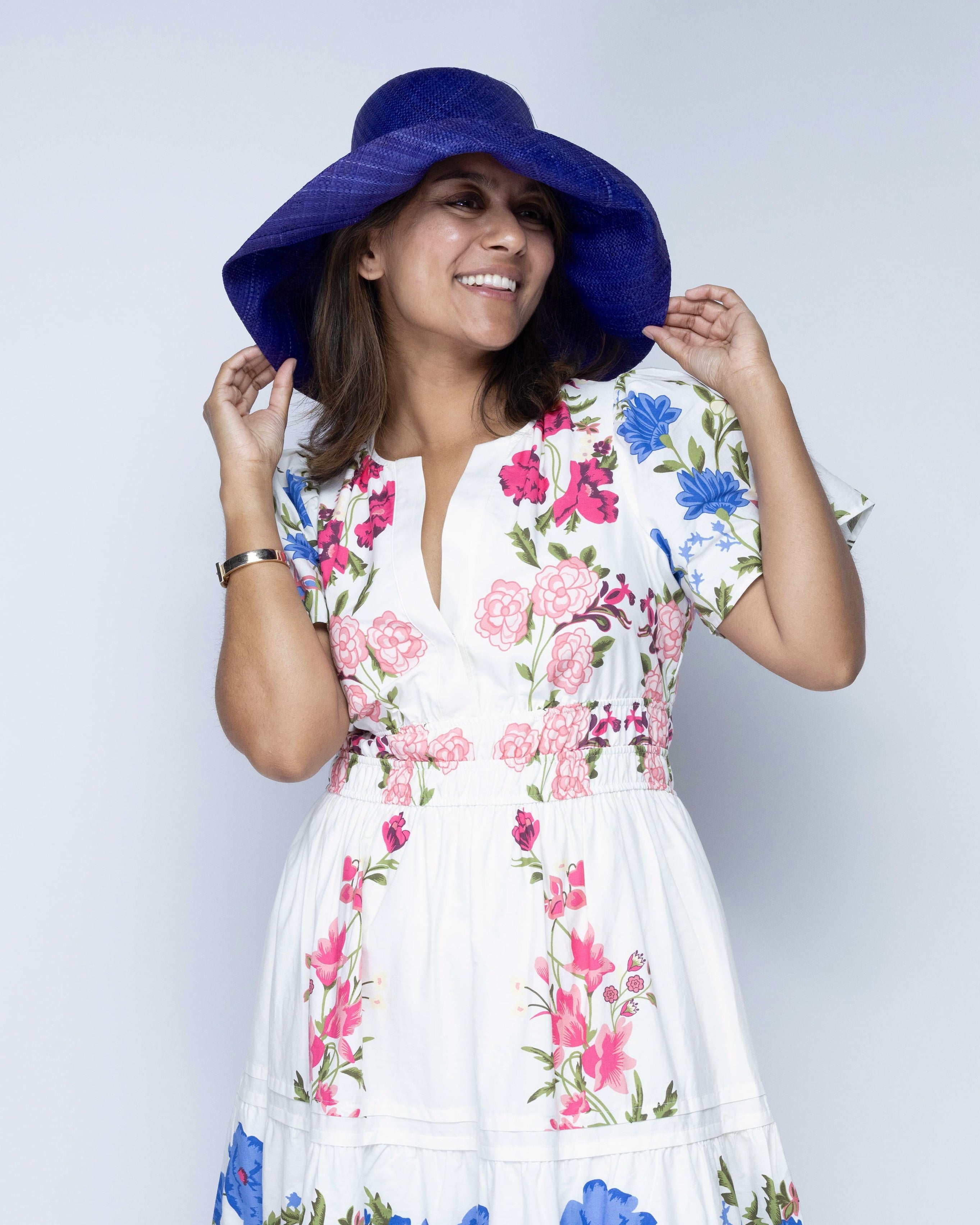Model wearing Monica 5" Wide Brim Blue Packable Straw Sun Hat handmade loomed raffia in a solid hue of blue lightweight malleable flexible sun protection hat - Shebobo