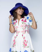 Model wearing Monica 5" Wide Brim Blue Packable Straw Sun Hat handmade loomed raffia in a solid hue of blue lightweight malleable flexible sun protection hat - Shebobo