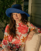 Model wearing Monica 5" Wide Brim Blue Packable Straw Sun Hat handmade loomed raffia in a solid hue of blue lightweight malleable flexible sun protection hat - Shebobo