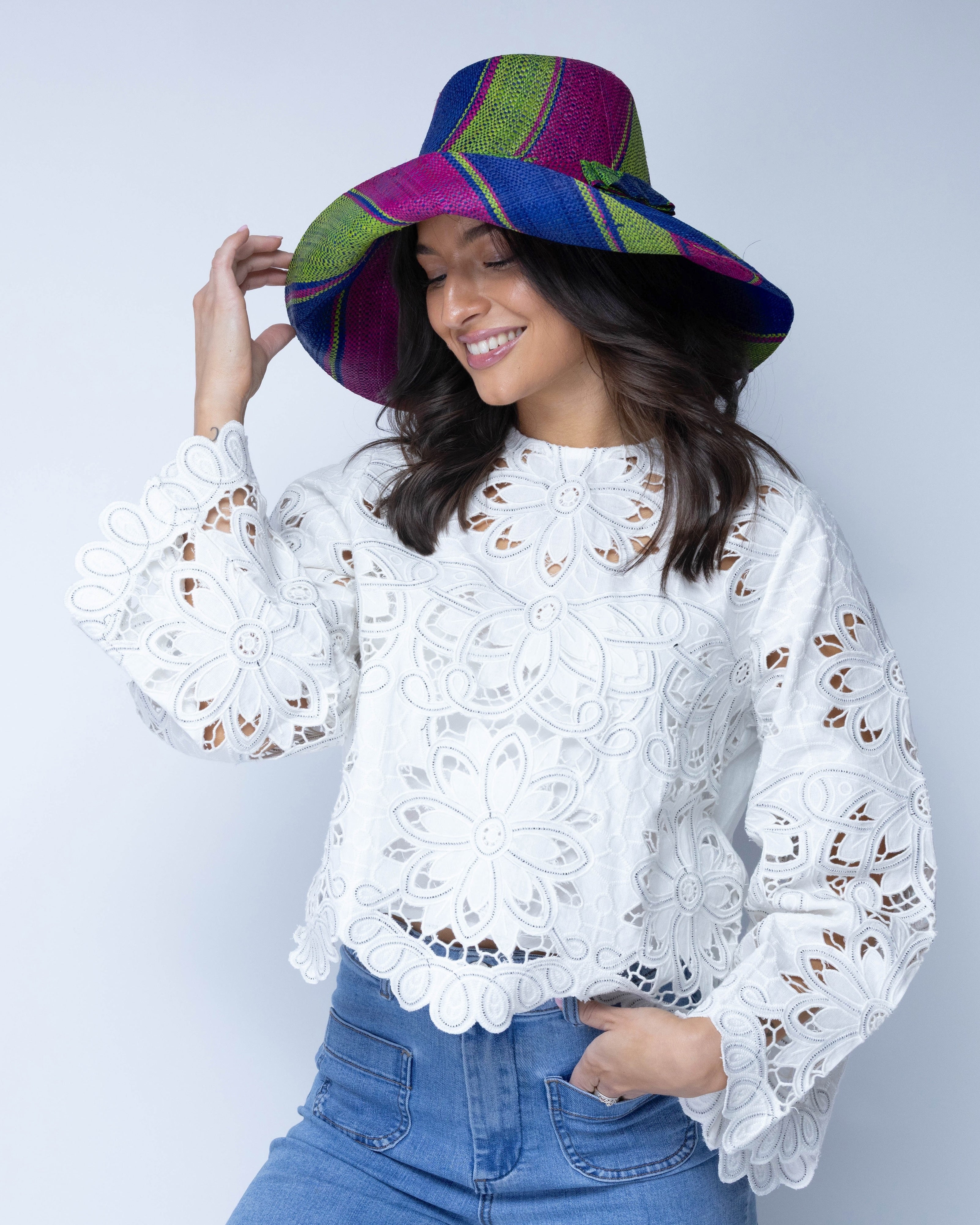 Model wearing Monica 5" Wide Brim Blueberry Swirl Multicolor Stripes Packable Straw Sun Hat Handmade loomed raffia in multi width bands of fuchsia pink, dusk navy/dark/blue, and lime green create a swirl pattern - Shebobo