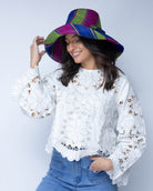 Model wearing Monica 5" Wide Brim Blueberry Swirl Multicolor Stripes Packable Straw Sun Hat Handmade loomed raffia in multi width bands of fuchsia pink, dusk navy/dark/blue, and lime green create a swirl pattern - Shebobo