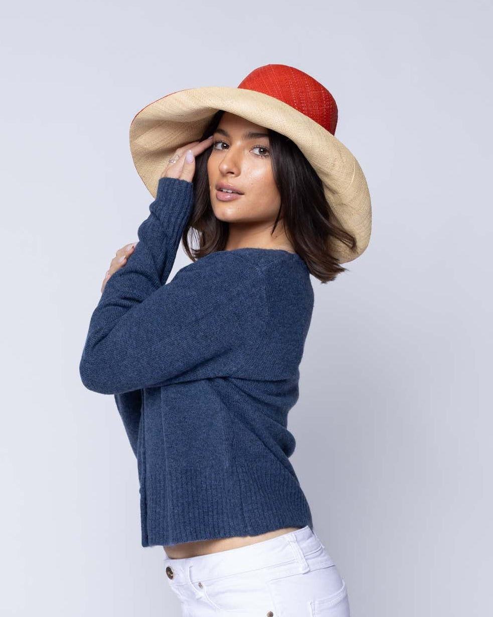 Model wearing Monica 5" & 7" Brim Two Tone Coral red/orange Straw Hat handmade loomed raffia color block pattern of the top half coral orange/red and the bottom half natural straw color - Shebobo