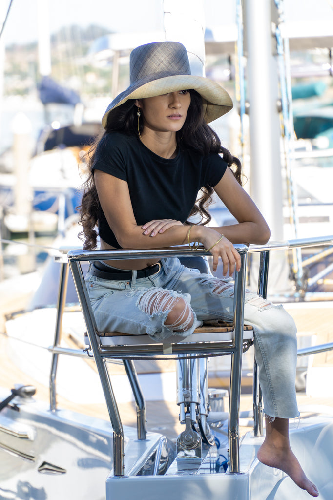 Model wearing Monica 5" wide brim two tone grey and natural packable raffia straw hat handmade loomed raffia top half grey, bottom half natural - Shebobo