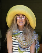 Model wearing Monica 5" & 7" Wide Brim Solid Color Packable Straw Sun Hat handmade loomed raffia in a solid hue of butter light/yellow  - Shebobo (with French Country Floral & Gingham Scarf)