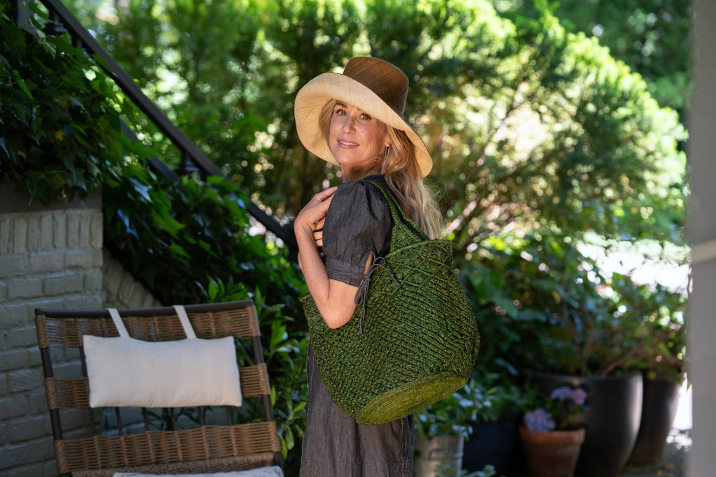 Model wearing Monica 5" Brim Two Tone Cinnamon Straw Hat handmade loomed raffia color block pattern of the top half cinnamon/tobacco/brown and the bottom half natural straw color - Shebobo (with Luca Macrame Diamond and Crochet Straw Handbag)