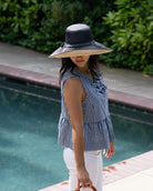 Model wearing Monica 5" & 7" Wide Brim Two Tone Black Packable Straw Sun Hat handmade loomed raffia color block pattern of the top half black and the bottom half natural straw color - Shebobo