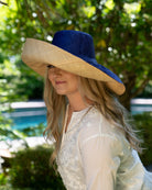 Model wearing Monica 7" wide brim two tone blue top and natural bottom handmade loomed raffia lightweight and packable straw sun hat - Shebobo