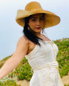 Model wearing Monica 7" Brim Two Tone Cinnamon Straw Hat handmade loomed raffia color block pattern of the top half cinnamon/tobacco/brown and the bottom half natural straw color - Shebobo