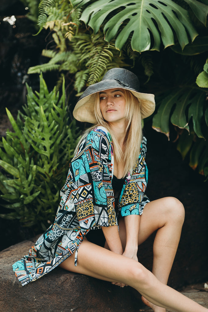 Model wearing Monica 5" & 7" Wide Brim Two Tone Black Packable Straw Sun Hat handmade loomed raffia color block pattern of the top half black and the bottom half natural straw color - Shebobo
