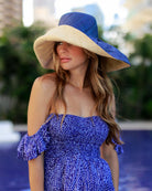 Model wearing Monica 7" wide brim two tone blue top and natural bottom handmade loomed raffia lightweight and packable straw sun hat - Shebobo