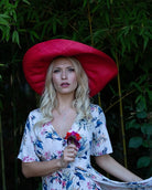 Model wearing Monica 7" Wide Brim Natural Packable Straw Sun Hat handmade loomed raffia in a solid hue of blue lightweight malleable flexible sun protection hat - Shebobo