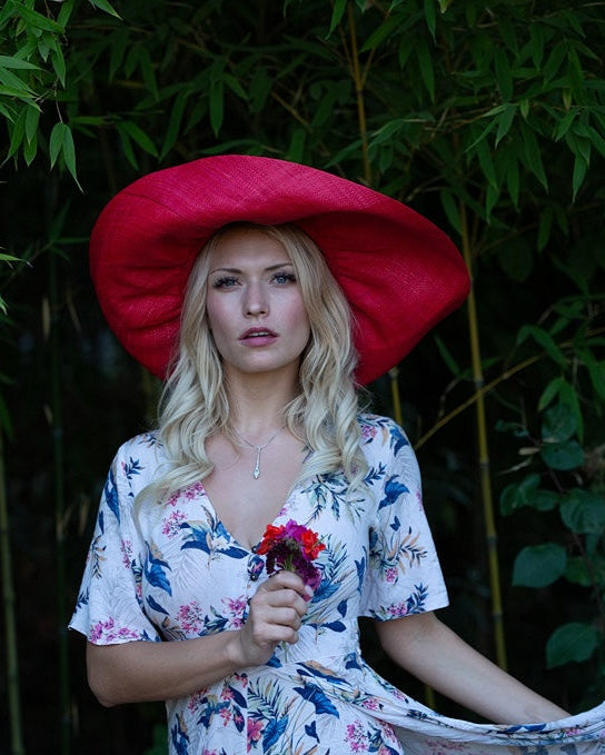 Model wearing Monica 7" Wide Brim Natural Packable Straw Sun Hat handmade loomed raffia in a solid hue of blue lightweight malleable flexible sun protection hat - Shebobo