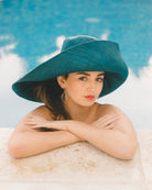 Model wearing Monica 7" wide brim teal dark/green/blue handmade loomed raffia packable lightweight straw sun hat - Shebobo