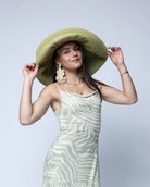 Model wearing Monica 7" Wide Brim Solid Color Packable Straw Sun Hat handmade loomed raffia in a solid hue of Matcha light/meadow/yellow/green  - Shebobo