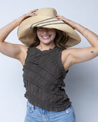 Model wearing Monica 5" & 7" Wide Brim Racing Stripe Packable Straw Sun Hats handmade loomed natural raffia palm fiber in a solid hue of natural straw color with a black three stripe racing stripe pinstripe pattern that creates a swirl around the crown and brim of the hat lightweight breathable sun protection - Shebobo