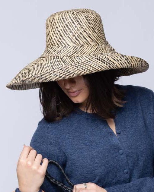 Model wearing Monica 5 inch or 7 inch Wide Brim Natural Two Tone Melange Packable Straw Sun Hat handmade loomed raffia in a multicolor heathered melange pattern of black and natural straw color creates a subtle swirl - Shebobo