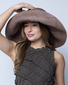 Model wearing Monica 7" Wide Brim Violet Smoke Packable Straw Sun Hat handmade loomed raffia in a solid hue of purple/grey lightweight malleable flexible sun protection hat - Shebobo