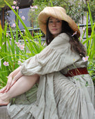 Model wearing Monica 5" or 7" wide brim natural and brights multicolor pinstripes packable raffia straw hat handmade loomed raffia in wide bands of natural straw color with narrow bands of lime green, bordeaux red, fuchsia pink, orange, cinnaon/tobacco/brown, blush orange/pink, etc. create a stripe swirl pattern - Shebobo