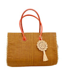 Monte Carlo Big Straw Beach Bag with Dreamcatcher Tassel Charm Embellishment handmade loomed raffia palm fiber in a solid hue of cinnamon tobacco/dark/brown with contrasting crosshatch stitch edging in natural straw color with matching crochet dreamcatcher disc and tuft tassel charm embellishment and leather handles oversized large handbag shoulder bag - Shebobo