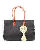 Monte Carlo Big Straw Beach Bag with Dreamcatcher Tassel Charm Embellishment handmade loomed raffia palm fiber in a solid hue of black with contrasting crosshatch stitch edging in natural straw color with matching crochet dreamcatcher disc and tuft tassel charm embellishment and leather handles oversized large handbag shoulder bag - Shebobo