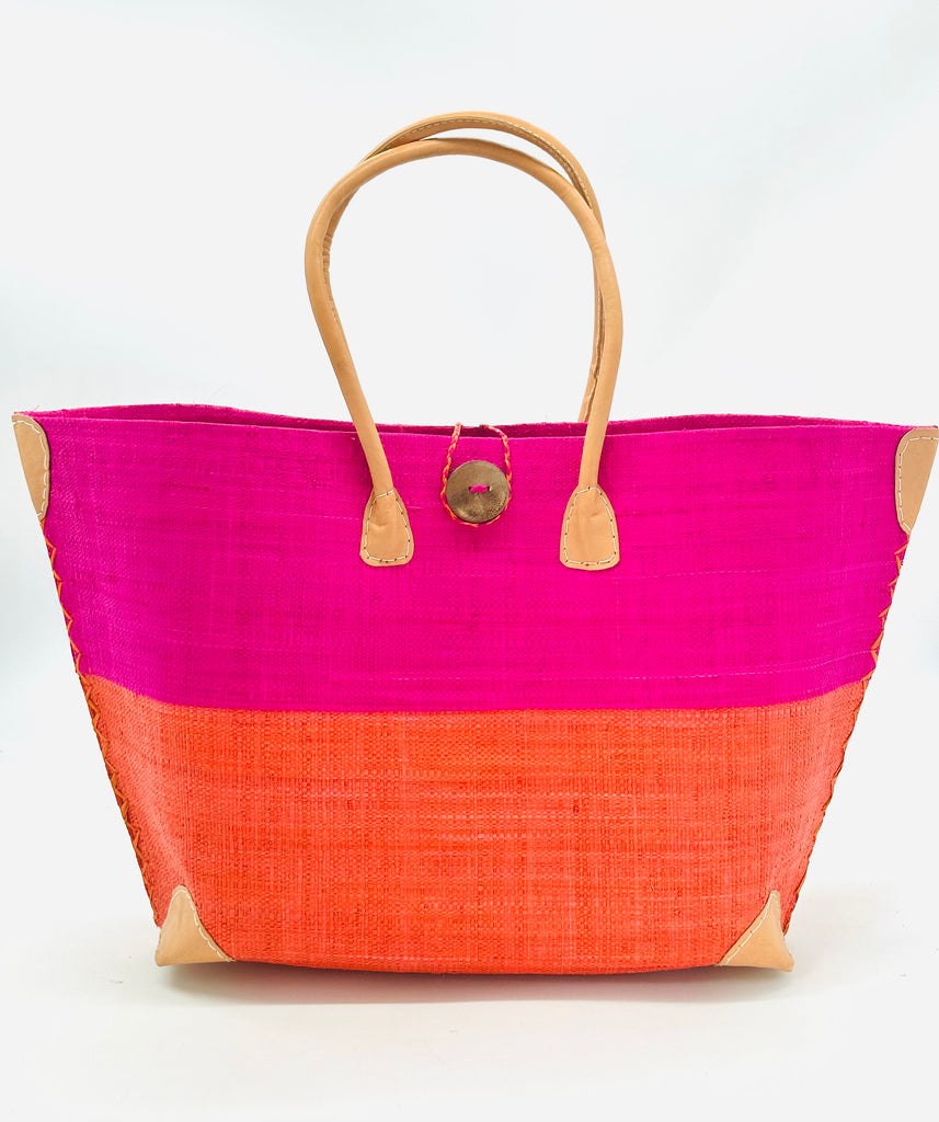 Monterey Two Tone Straw Tote Bag handmade loomed raffia fibers in a color block pattern of fuchsia pink colored upper half, and coral red/orange lower half - Shebobo