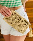 Model wearing Nasolo Crochet Straw Clutch bag with zipper closure and tassel zipper pull handmade granny square pattern raffia pouch purse in Natural handbag - Shebobo