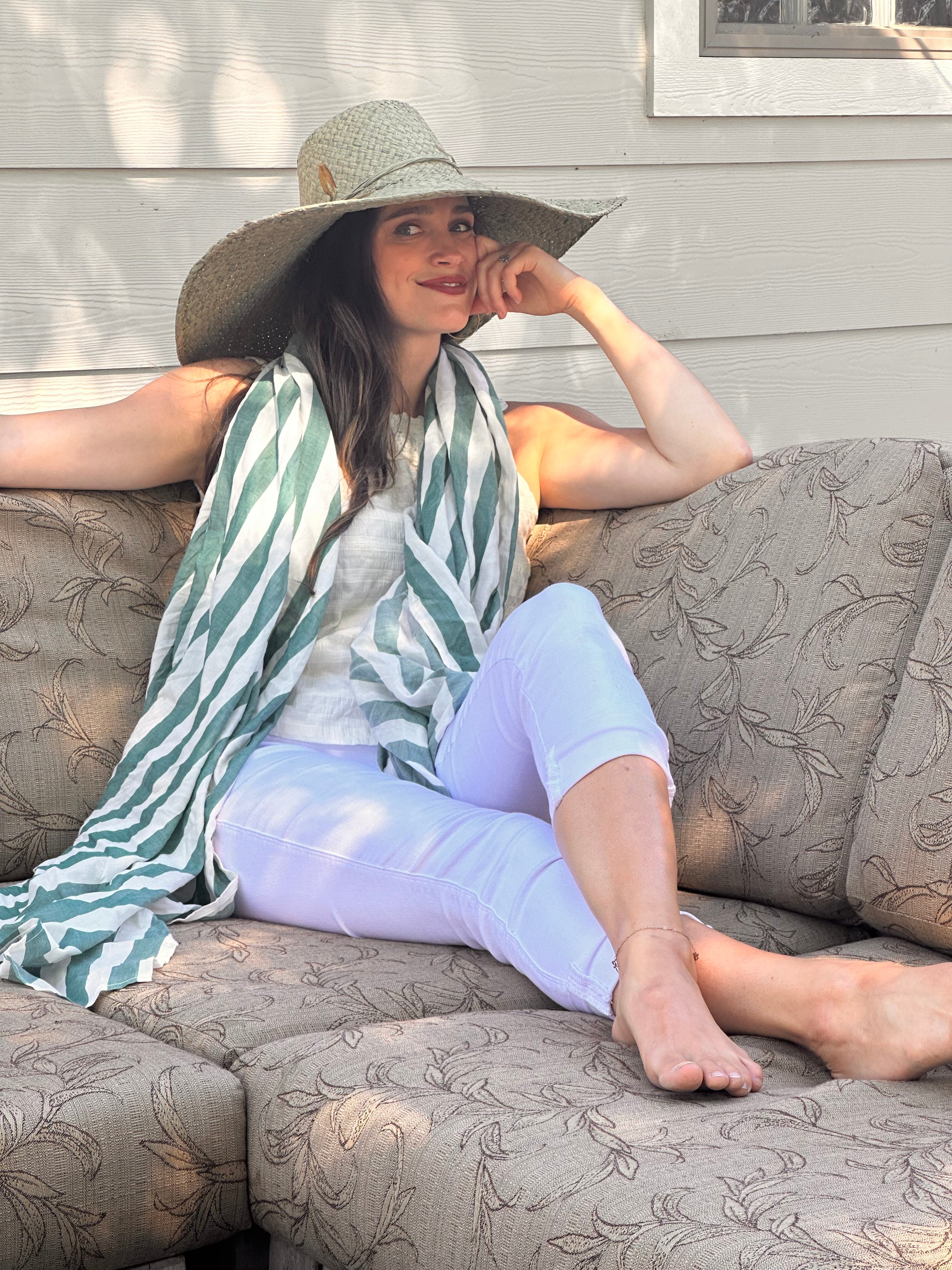 Model wearing 7" Wide Brim Natasha Ocean Mist Woven XL Straw Sun Hat handmade woven natural raffia palm fiber in a solid hue of ocean mist sage/green with matching adjustable twisted raffia hat band and and extra wide brim - Shebobo