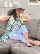 Model wearing 7" Wide Brim Natasha Ocean Mist Woven XL Straw Sun Hat handmade woven natural raffia palm fiber in a solid hue of ocean mist sage/green with matching adjustable twisted raffia hat band and and extra wide brim - Shebobo