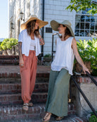 Models wearing 7" Wide Brim Natasha Natural Woven XL Straw Sun Hat handmade woven natural raffia palm fiber in a solid hue of natural straw or ocean mist sage/light/soft/green color with matching adjustable twisted raffia hat band and and extra wide brim - Shebobo