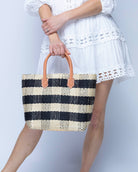 Model wearing Newport Black Gingham Sisal Basket Bag handmade woven natural sisal fibers in a two tone color plaid pattern of black and natural straw color handbag with leather handles purse beach bag - Shebobo