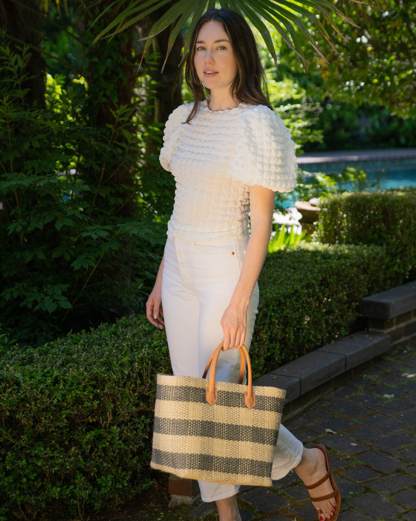 Model wearing Newport Grey Gingham Sisal Basket Bag handmade woven natural sisal fibers in a two tone color plaid pattern of grey and natural straw color handbag with leather handles purse beach bag - Shebobo