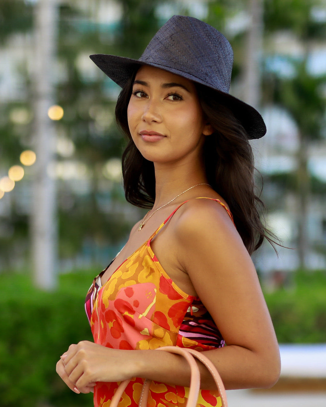 Model wearing Panama black unisex straw hat handmade 3" brim loomed raffia black travel hat sun hat - Shebobo