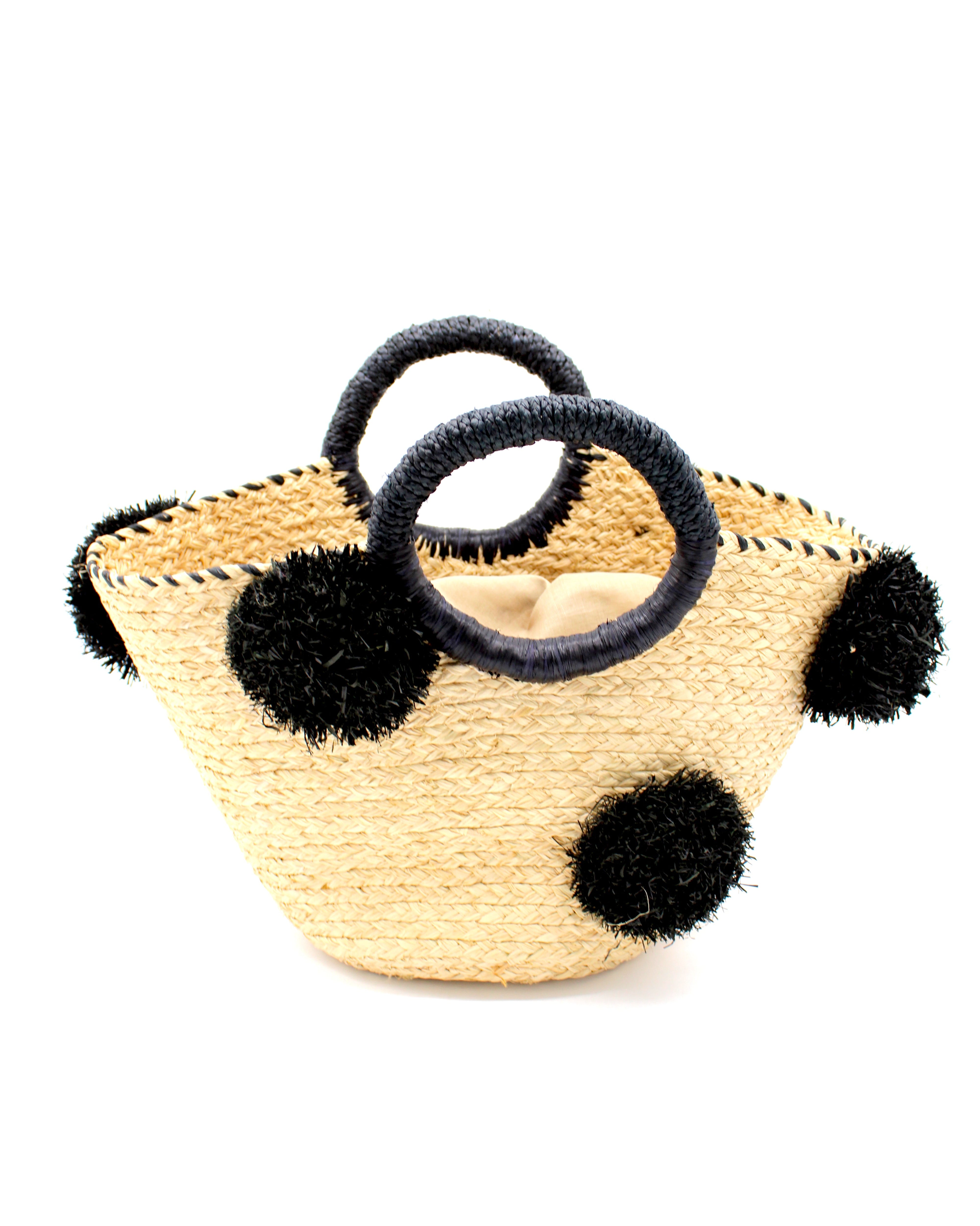 Phi Phi Black and Natural Braided Straw Basket with Oversized Raffia Poufs handmade raffia palm fiber braided into a solid hue of natural straw color with three randomly placed black hand-brushed fringe poufs per side for embellishment with matching loop wrap top edging and matching crochet loop/braided handles bag handbag - Shebobo