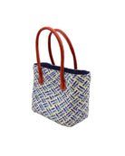 Side view Pianina Azure Multi Small Straw Basket Bag handmade from woven natural raffia palm fiber in a multicolor cross weave pattern of turquoise, denim retro/light/blue, natural straw color, and navy blue handbag purse with leather handles - Shebobo
