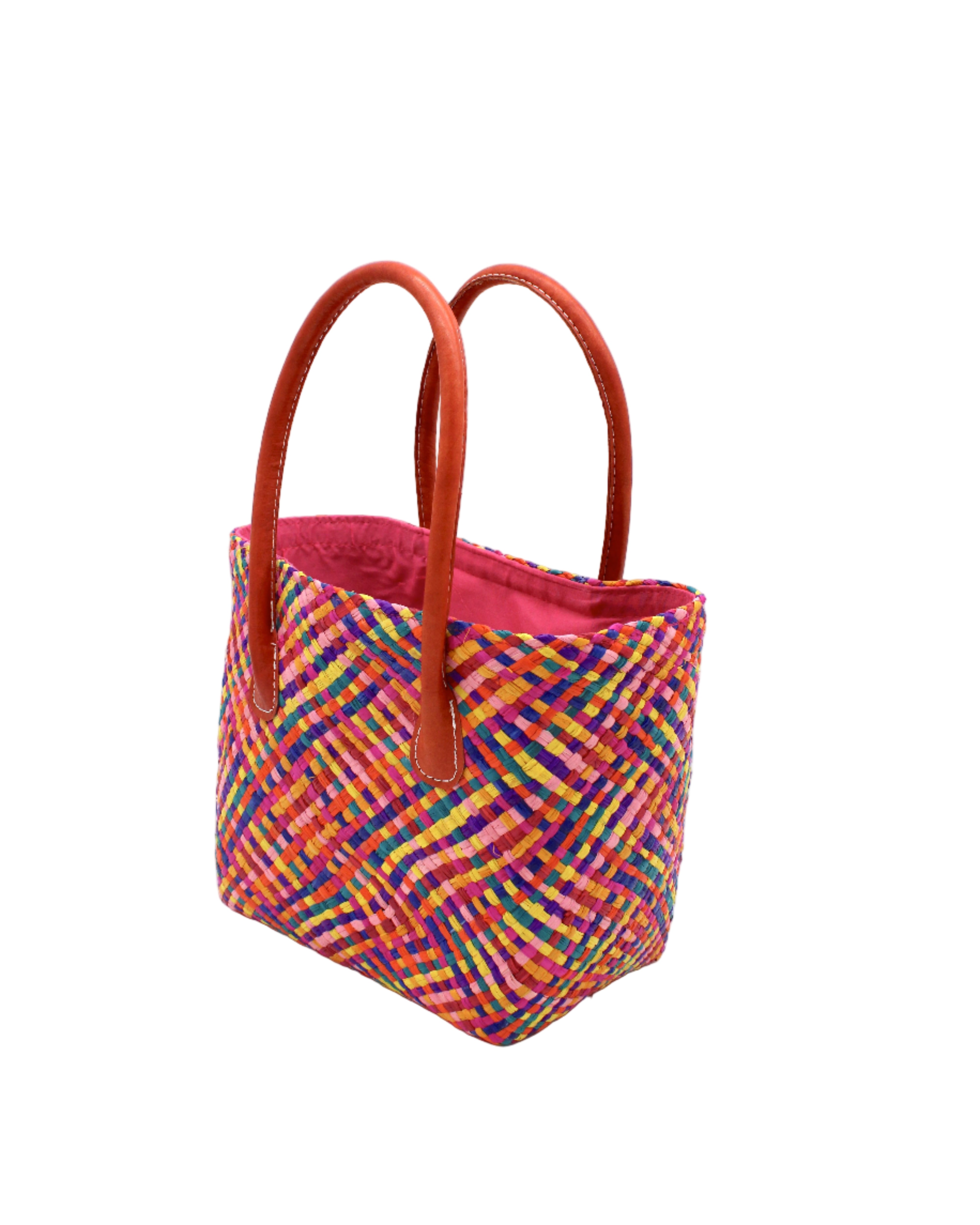 Side view Pianina Raspberry Multi Small Straw Basket Bag handmade from woven natural raffia palm fiber in a multicolor cross weave pattern of turquoise blue, coral orange, orchid purple, bordeaux red, fuchsia pink, light pink, saffron yellow, yellow, and navy blue handbag purse with leather handles - Shebobo