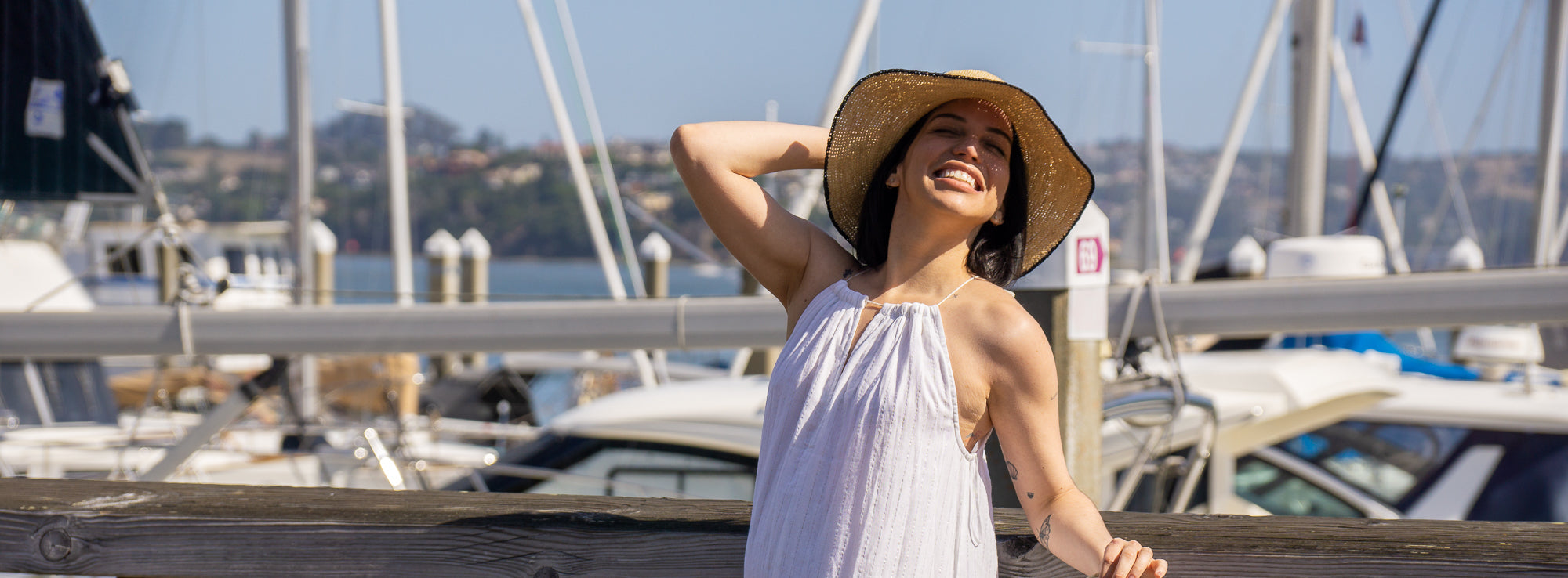 Model wearing Rachel Crochet Black handmade straw sun hat black trim woven edge and matching adjustable hat band on natural straw colored raffia hat- Shebobo