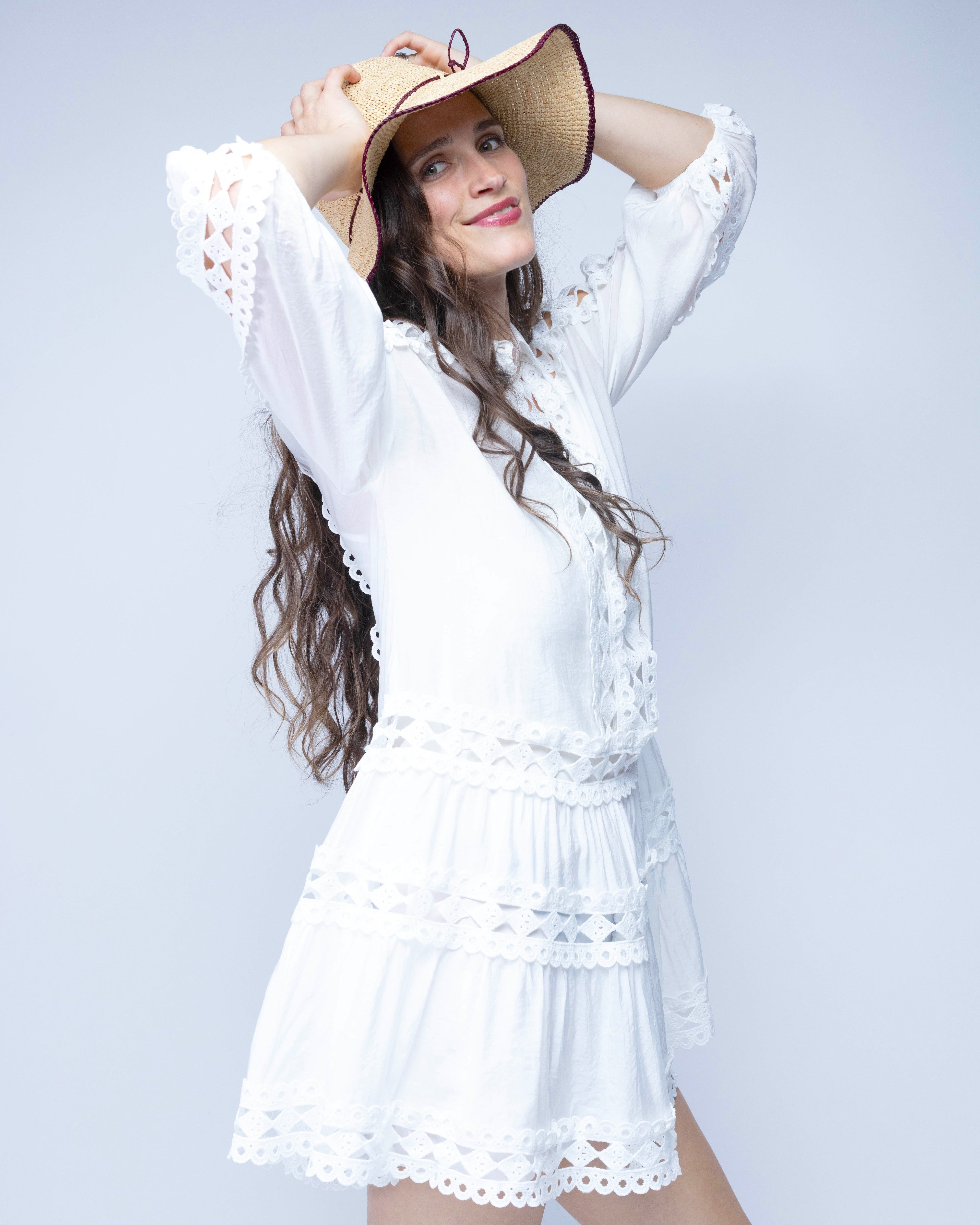 Model wearing 4 inch brim Rachel Crochet Umberwine handmade straw sun hat umberwine bordeaux/claret/deep/dark/red/purple trim woven edge and matching adjustable hat band on natural straw colored raffia hat - Shebobo