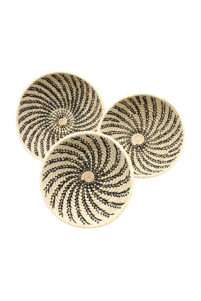 Raffia Straw Decor Display Basket Bowls: Set of 3 handmade woven natural raffia palm fiber in a crochet loop technique concentric coiled circular pattern with natural straw color centered in the bottom and that go up the sides of the bowls with contrasting black swirl stitch pattern and matching natural rim/edge set of small, medium, and large straw display bowls - Shebobo