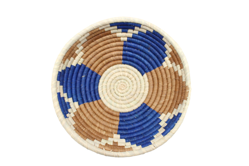 Detail view Raffia Straw Decor Display Basket Bowls: Set of 3 handmade woven natural raffia palm fiber in a crochet loop technique concentric coiled circular pattern with natural straw color centered in the bottom with blue, cinnamon/tobacco/brown, and natural geometric floral design pattern up the sides of the bowls set of small, medium, and large straw display bowls - Shebobo