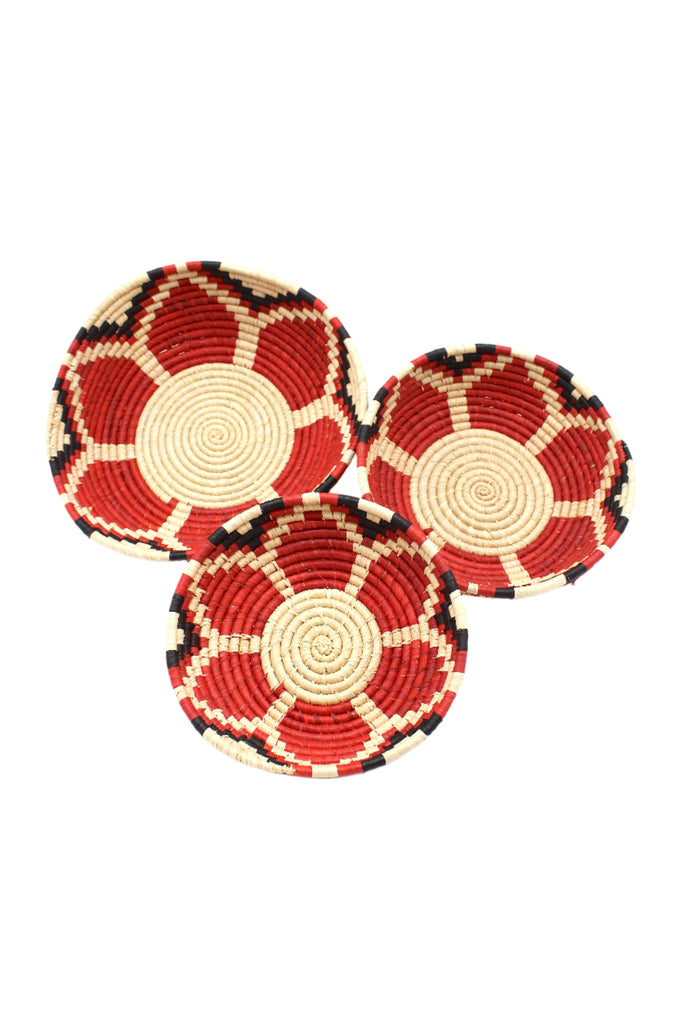 Raffia Straw Decor Display Basket Bowls: Set of 3 handmade woven natural raffia palm fiber in a crochet loop technique concentric coiled circular pattern with natural straw color centered in the bottom with red, natural, and black geometric floral design pattern up the sides of the bowls set of small, medium, and large straw display bowls - Shebobo