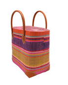 Side view Rayo Stripes Straw Basket Bag Raspberry Swirl handmade loomed natural raffia palm fiber in a multicolor multi width horizontal stripe pattern of coral orange, red, purple, midori lime/green, light pink, yellow, blue, and natural straw color, etc. with leather handles and accents tote beach bag - Shebobo