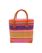 Rayo Stripes Straw Basket Bag Raspberry Swirl handmade loomed natural raffia palm fiber in a multicolor multi width horizontal stripe pattern of coral orange, red, purple, midori lime/green, light pink, yellow, blue, and natural straw color, etc. with leather handles and accents tote beach bag - Shebobo
