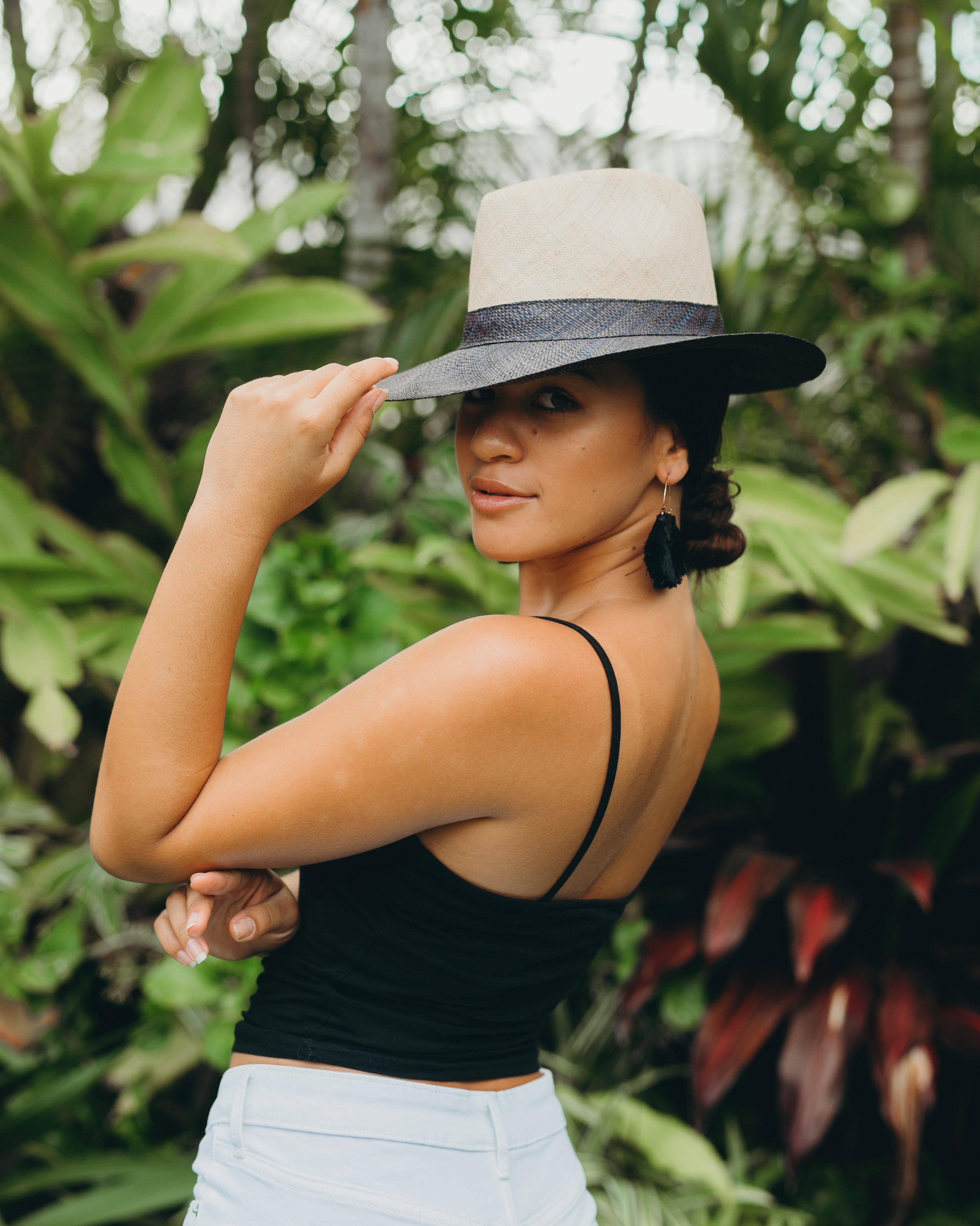 Model wearing Riley 3" Brim Panama Unisex Two Tone Straw Hats handmade loomed raffia palm fiber in a solid hue of natural straw color on the crown and solid black on the brim with matching attached hat band lightweight breathable uv/sun protection straw sun hat - Shebobo