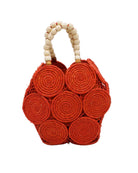 Romy Coral Crochet Disc Straw Handbag with Wooden Bead Handles handmade natural raffia palm fiber in a solid hue of coral orange/red in a crochet coiled circular flat disc attached together with macrame knot technique with a geometric hexagonal overall shape with seven discs per side two above and below a horizontal row of three per side and a single row comprising the side of the bag with beige carved round wooden beaded handles purse - Shebobo