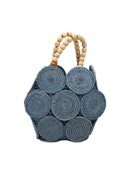 Romy Denim Crochet Disc Straw Handbag with Wooden Bead Handles handmade natural raffia palm fiber in a solid hue of denim retro/light/blue in a crochet coiled circular flat disc attached together with macrame knot technique with a geometric hexagonal overall shape with seven discs per side two above and below a horizontal row of three per side and a single row comprising the side of the bag with beige carved round wooden beaded handles purse - Shebobo