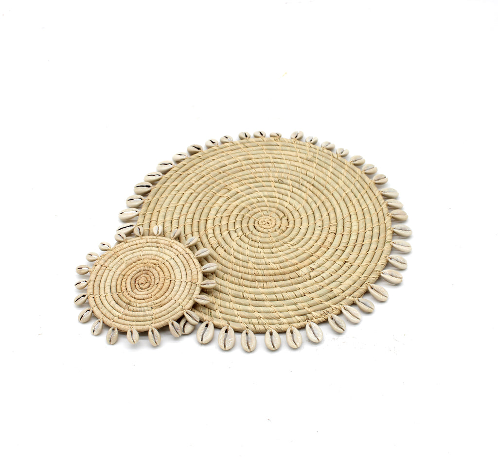 Detail view Round Raffia Straw Coasters & Placemats with Cowrie Shell Edge Set of 6 handmade woven raffia palm fiber in a solid hue of natural straw color with coiled loop texture discs with cowrie shell edge embellishment set of six - Shebobo