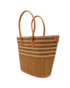 Side view Santa Cruz Tobacco & Natural Two Tone Wide Stripe Small Straw Tote Bag handmade loomed natural raffia palm fiber in a two tone color block pattern of solid Tobacco dark/cinnamon/brown on the bottom half of the bag and two tone even width horizontal stripes of tobacco and natural straw color on the top half of the bag with leather handles and details beach bag handbag purse - Shebobo