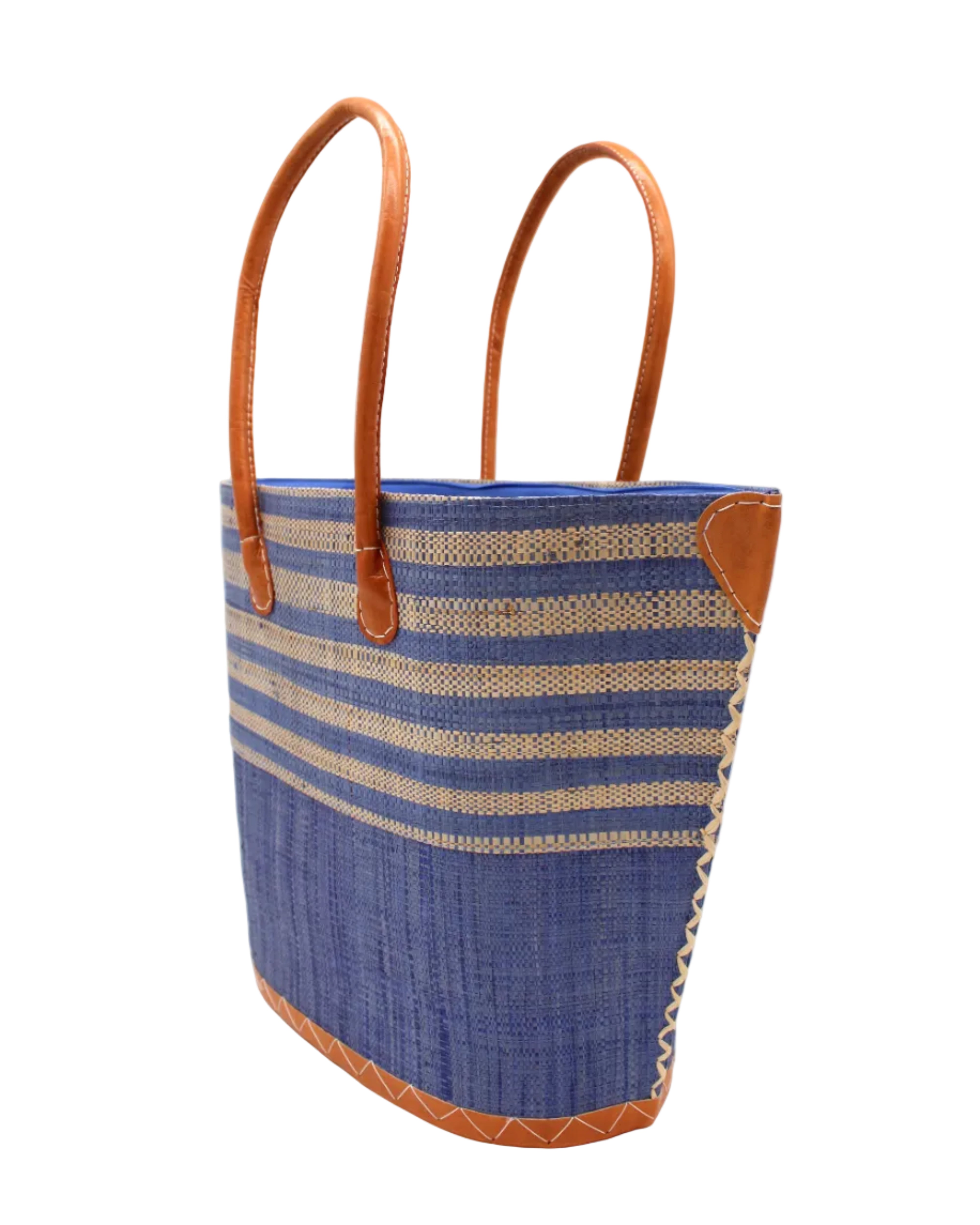 Side view Santa Cruz Denim & Natural Two Tone Wide Stripe Small Straw Tote Bag handmade loomed natural raffia palm fiber in a two tone color block pattern of solid denim retro/light/blue on the bottom half of the bag and two tone even width horizontal stripes of denim and natural straw color on the top half of the bag with leather handles and details beach bag handbag purse - Shebobo