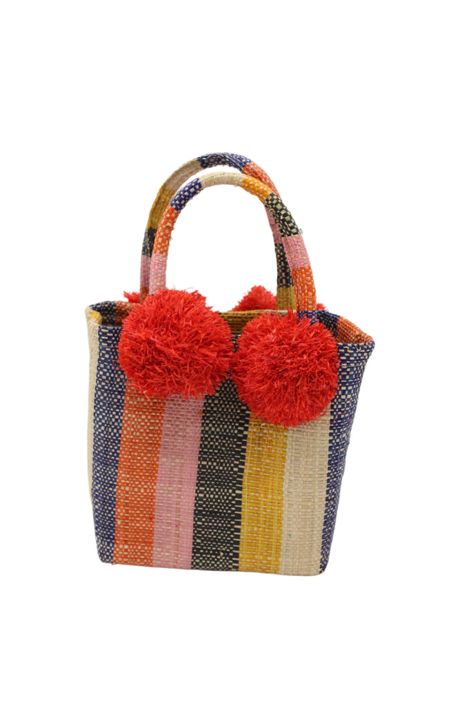 Schooner Candyland Stripe Straw Mini Bag with Pompom Accent handmade loomed natural raffia palm fiber in multi width vertical multicolor stripe pattern of dusk navy/dark/blue, coral orange/red, light pink, black, saffron yellow/orange, and natural straw color, etc. with four matching raffia pompom embellishments at the base of each handle attachment tiny purse extra small handbag - Shebobo
